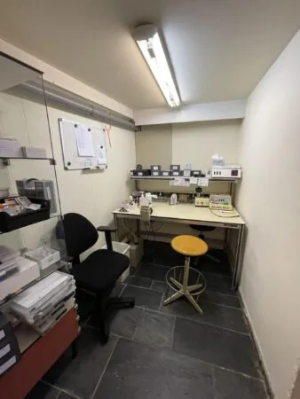 Kleine werkruimte in de Prinses Mariannelaan met bureaus, stoelen en elektronische apparatuur.